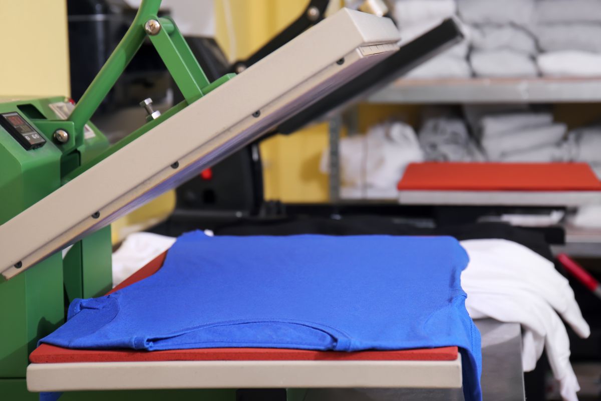 A T-shirt being printed under screen printing machine