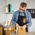 A guy packing customized products for selling