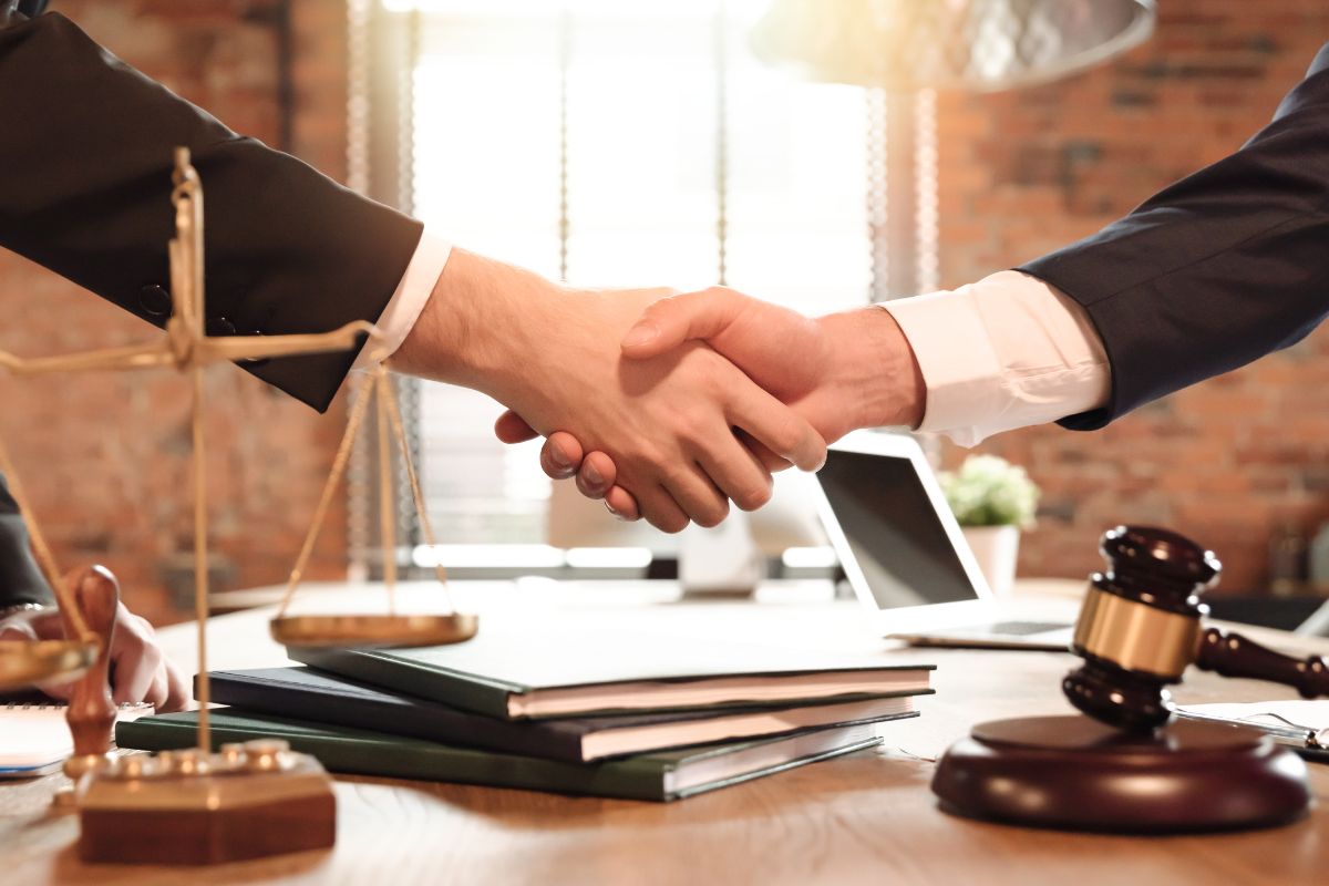 Two guys shaking hands after fulfilling the legal needs of customized products business