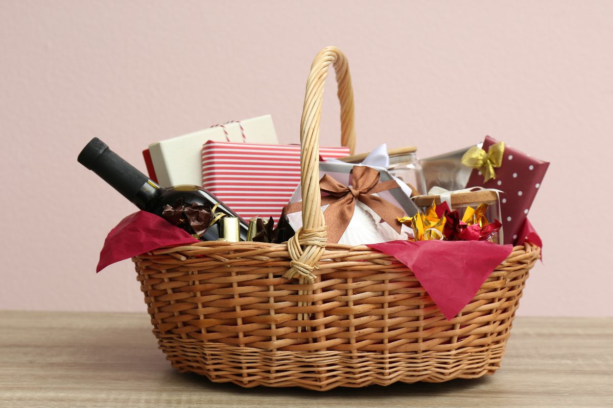 A basket filled with several Christmas presents for employees.