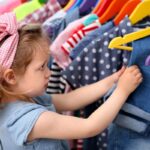 A cute girl checking a kids clothing line