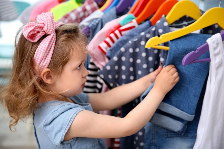 A cute girl checking a kids clothing line