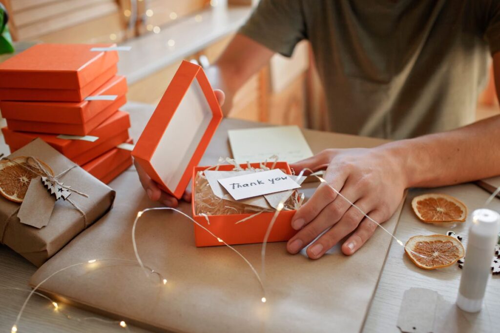 A guy packaging and personalizing presents to be given to church members.