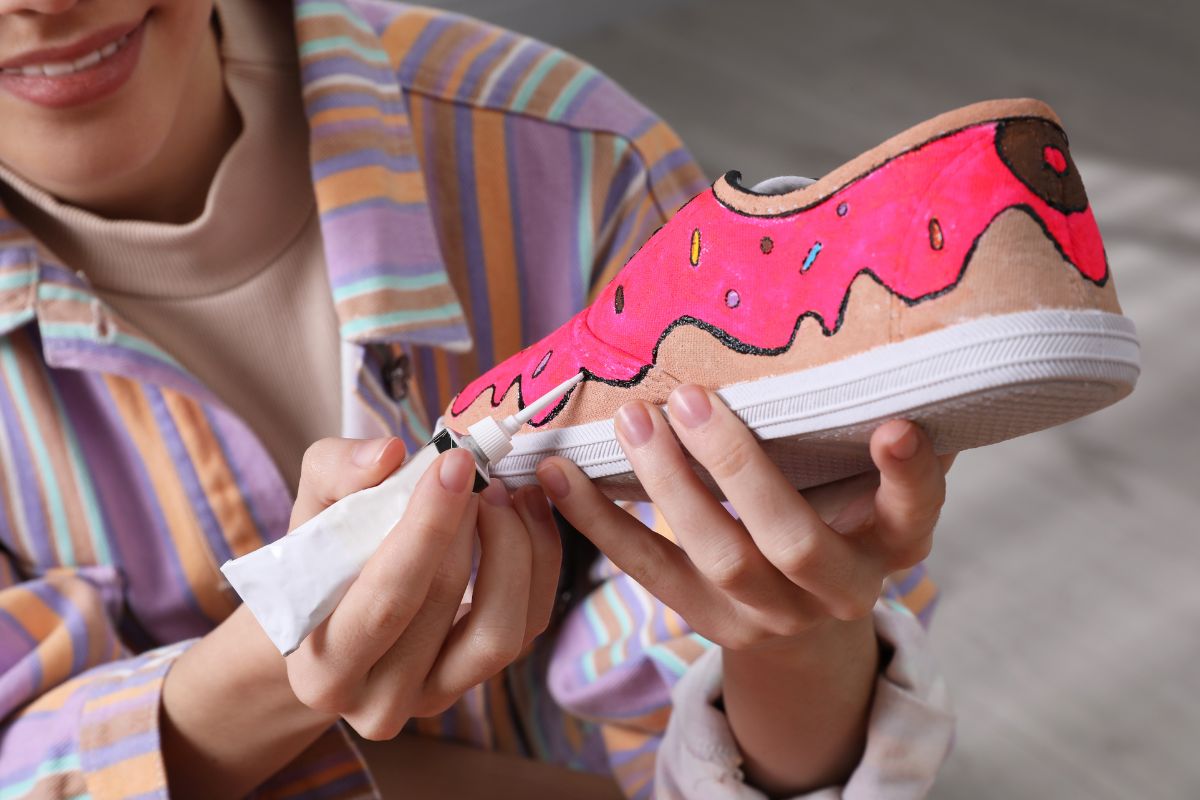 A lady crafting more design on print on demand shoes to make it more attractive.