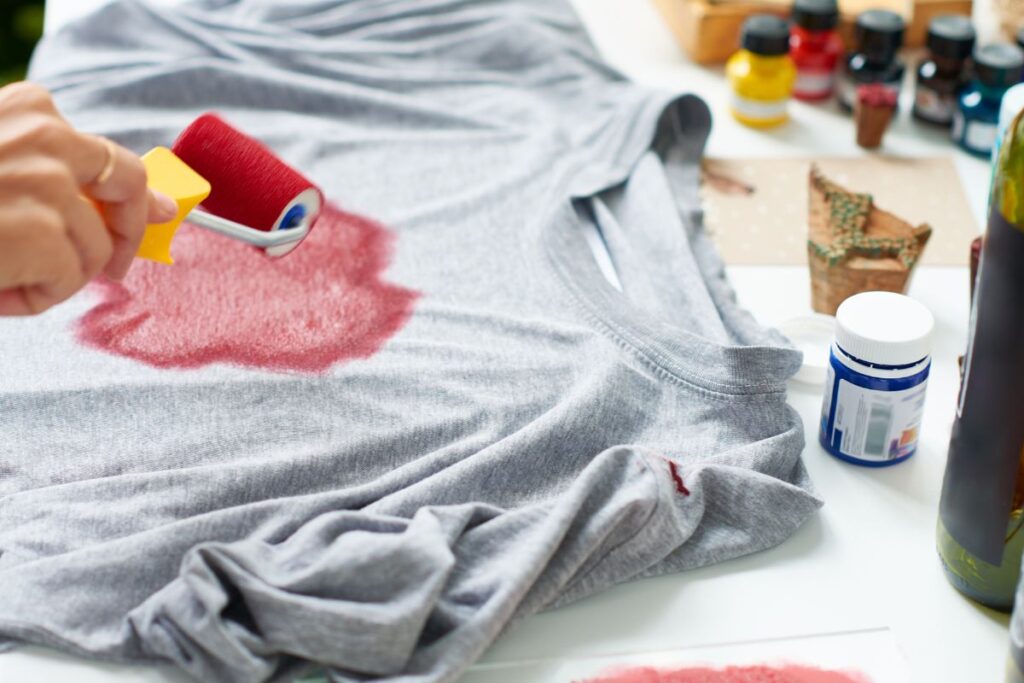 A lady creating attractive design on t-shirt.