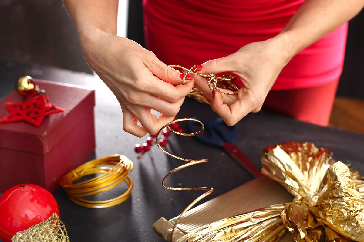 A lady packing Christmas gift item.