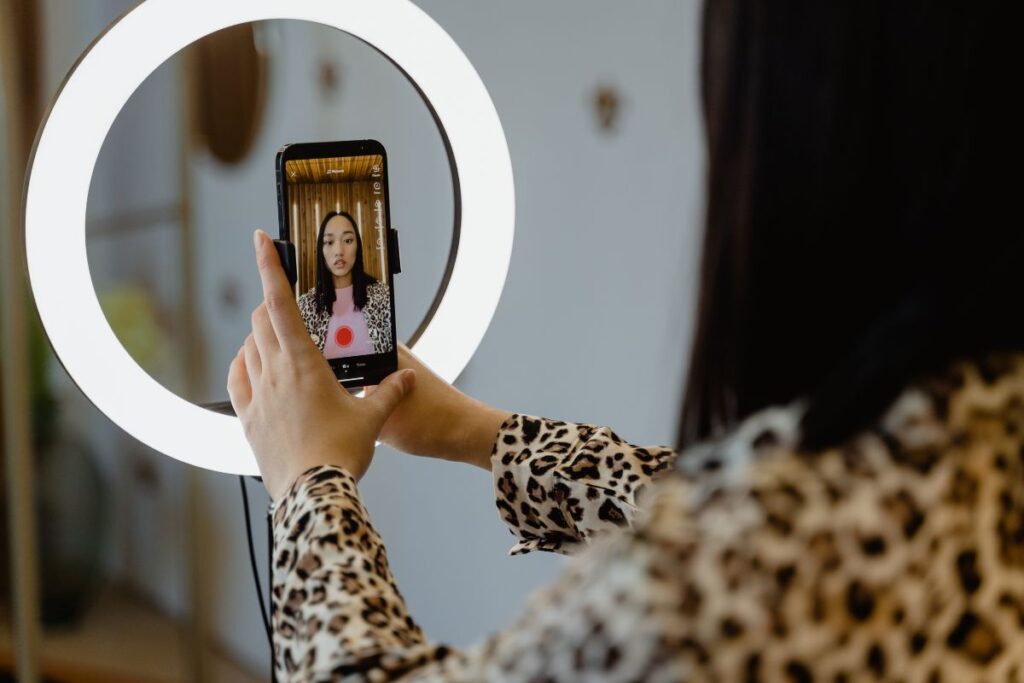 A lady recording content for her tik-tok video.