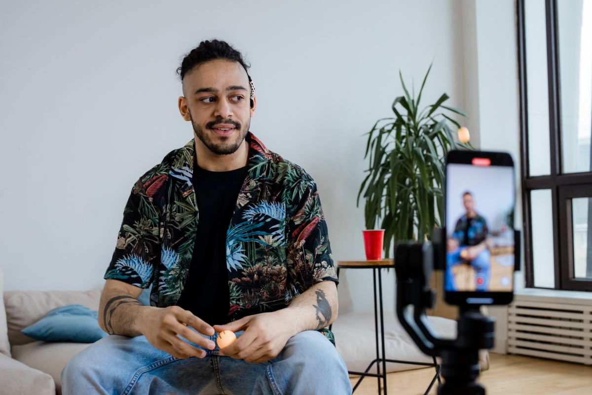 A person creating instagram content and showing off his print on demand shirt.