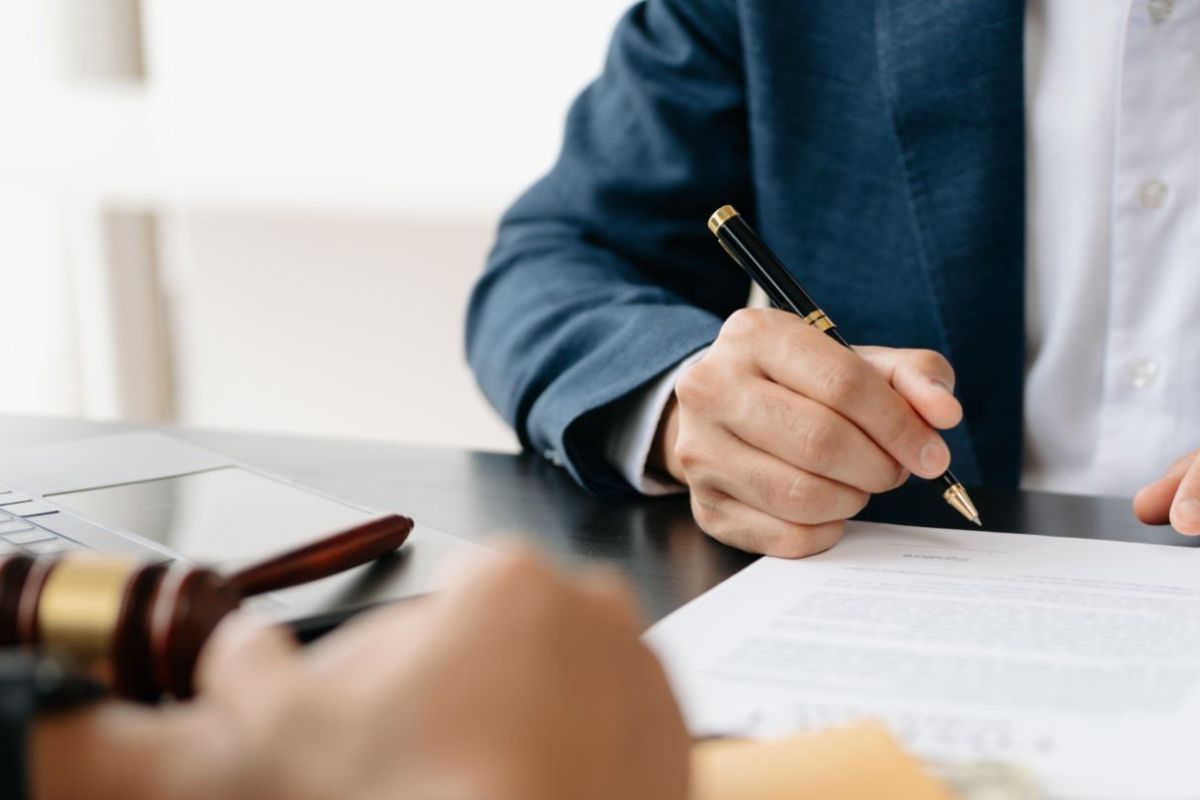 A person filling legal document and making a business plan on how to start akids clothing line