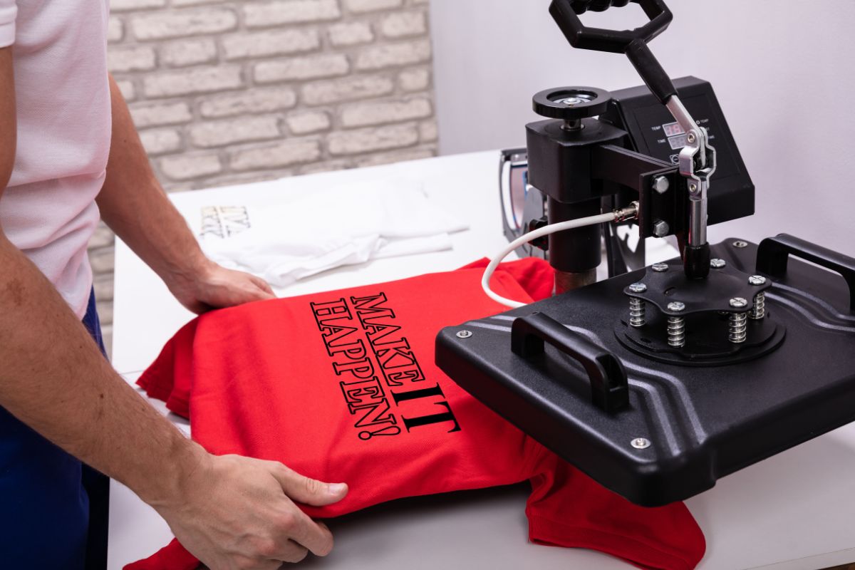 A person printing t-shirt as a side hustle for his print on demand business.