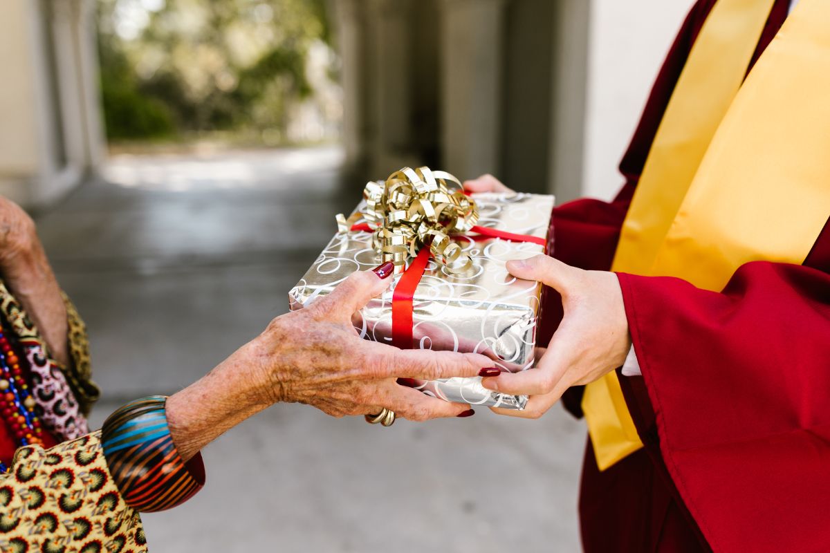 A student receiving Christmas gift from his teacher.