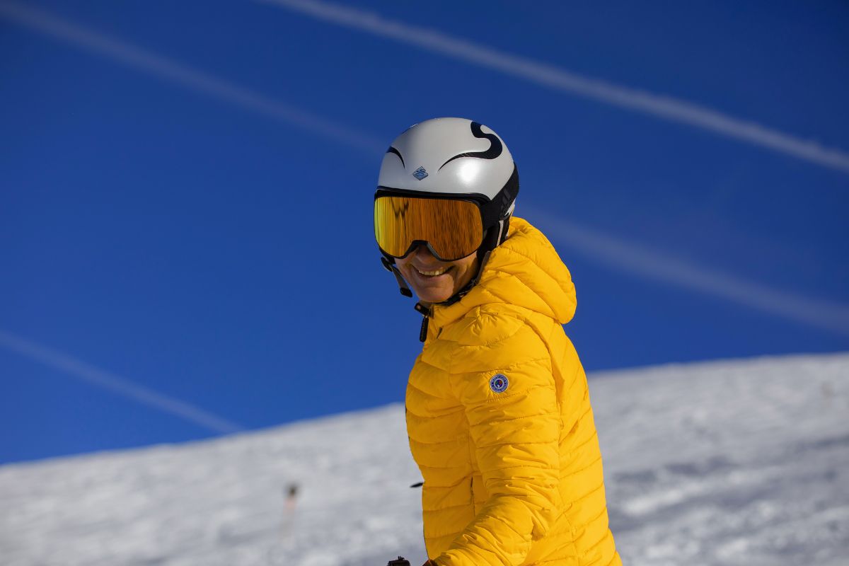 A woman skiing on a mountain in a puffer jacket