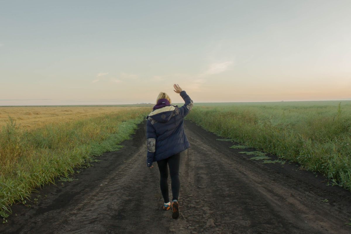 A woman traveling outside in her puffer jacket