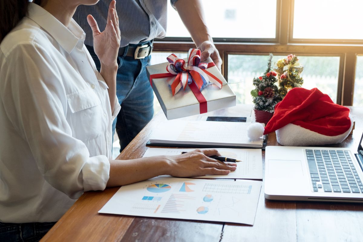 An employee getting gift from her boss for christmas.