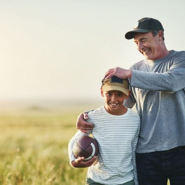 Father and son wearing Best Dad Hats and playing with each other.