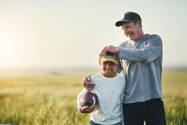 Father and son wearing Best Dad Hats and playing with each other.