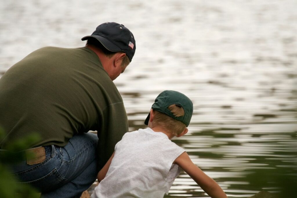 Father and son wearing dad hat.