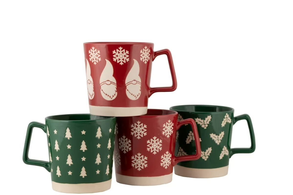 Four beautiful custom designed christmas gift cups kept with each other.