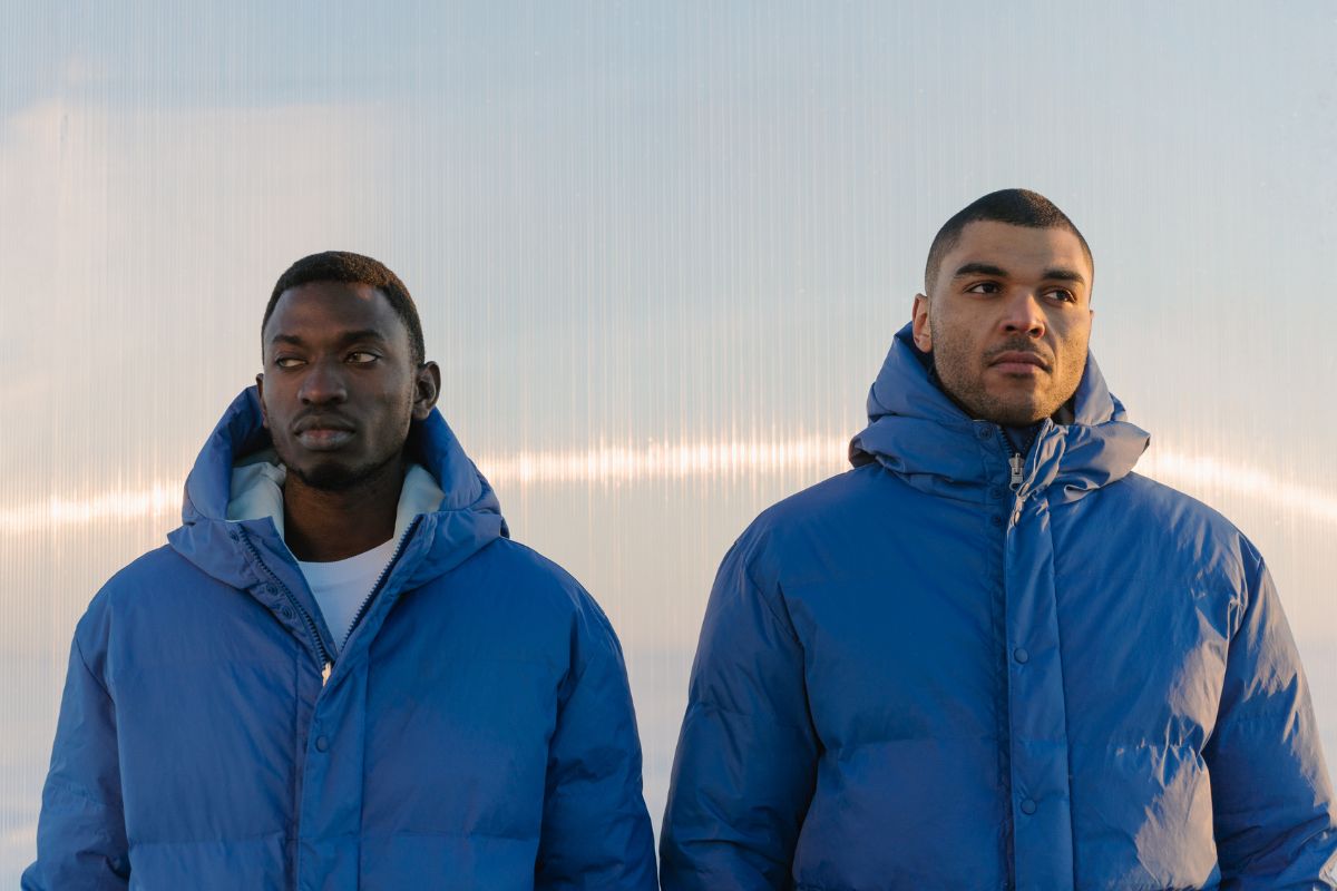 Two men wearing heavyweight puffer jackets.