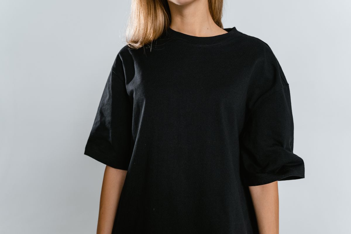 A lady wearing black colored heavy weight t-shirt