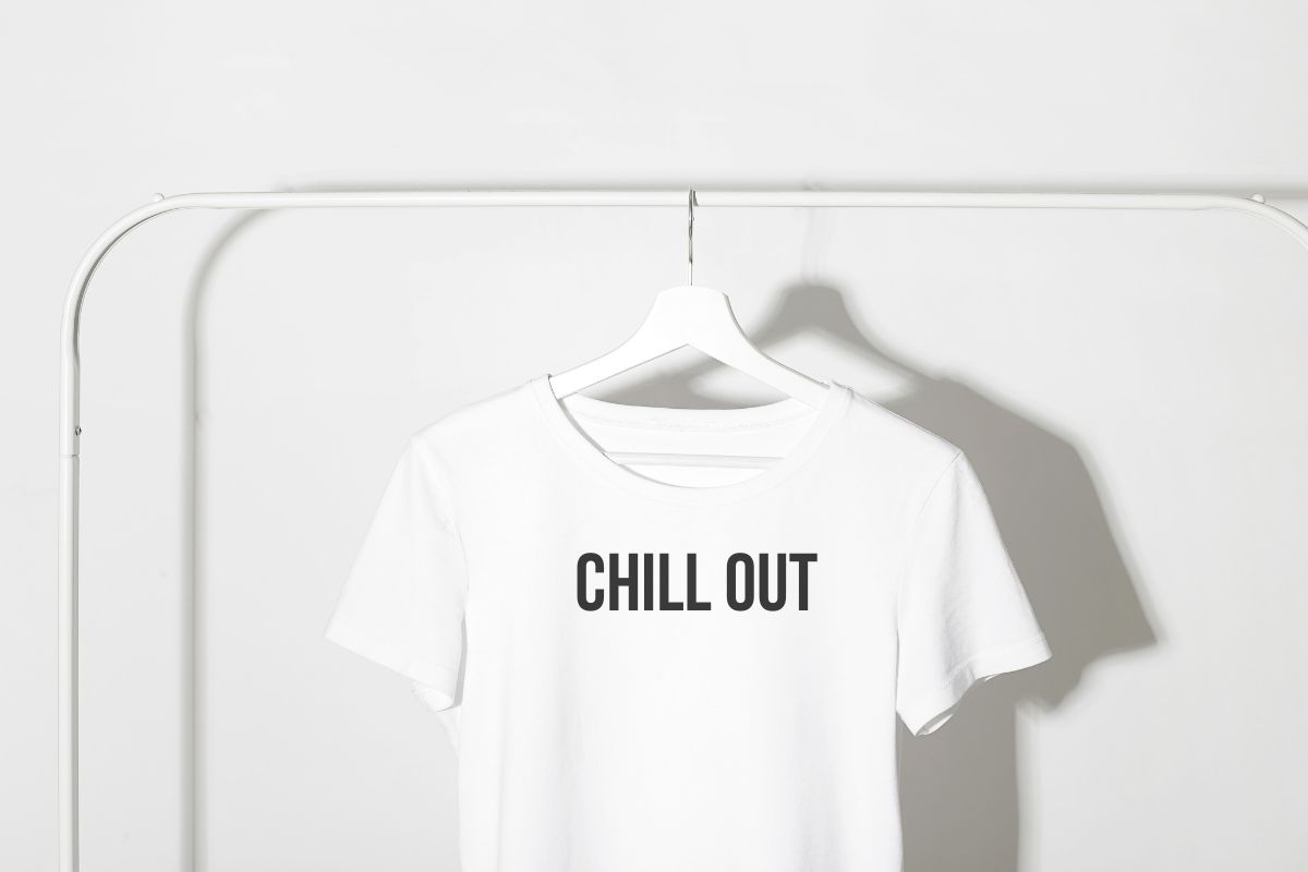 Chill Out written on a white t-shirt in Bebas Neue font