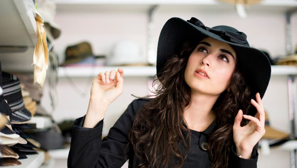 A lady showing how to start a hat business by openeing her own shop