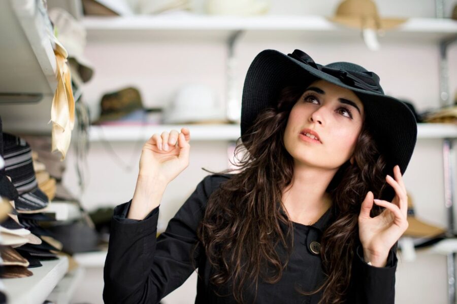 A lady showing how to start a hat business by openeing her own shop