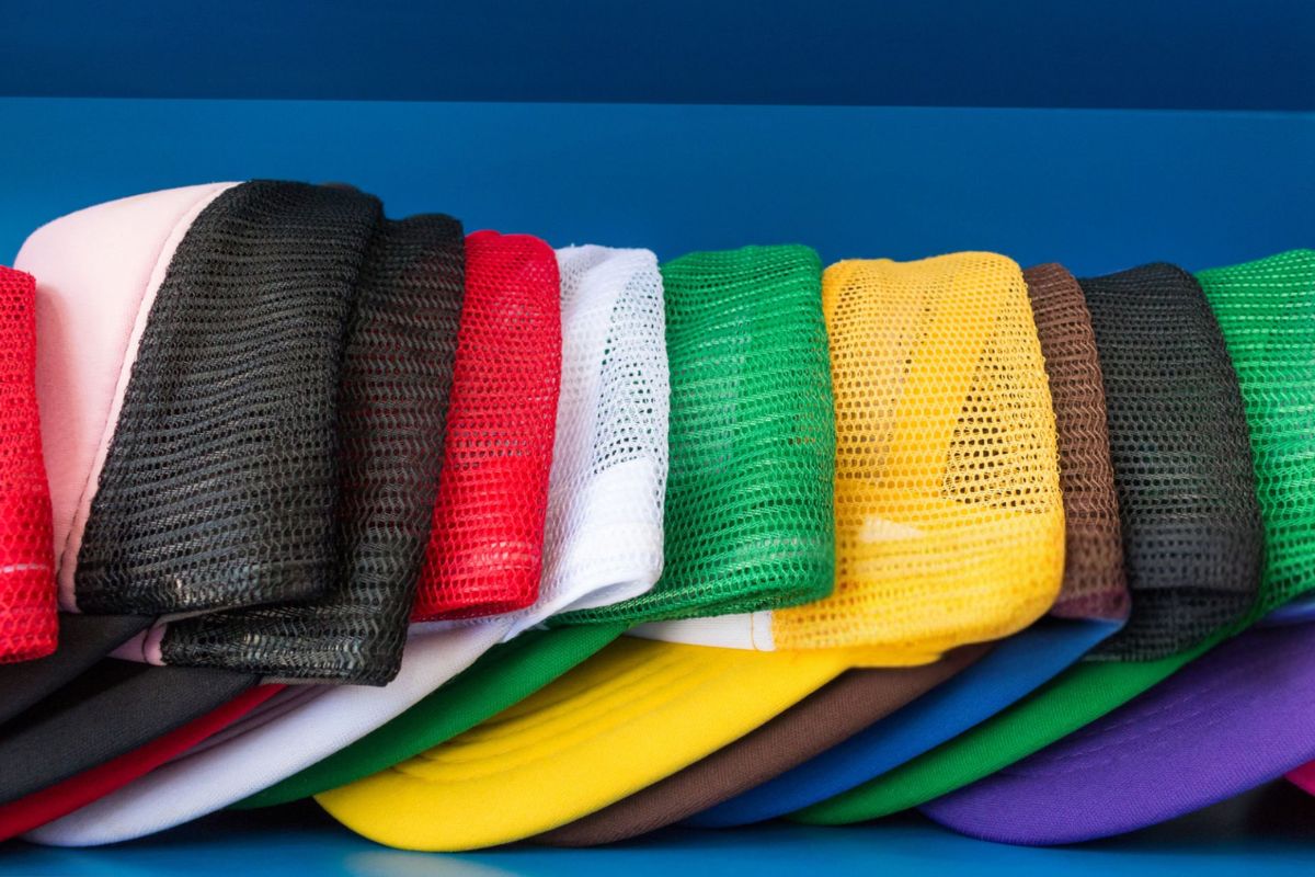 A collection of different colored mesh hats kept with others