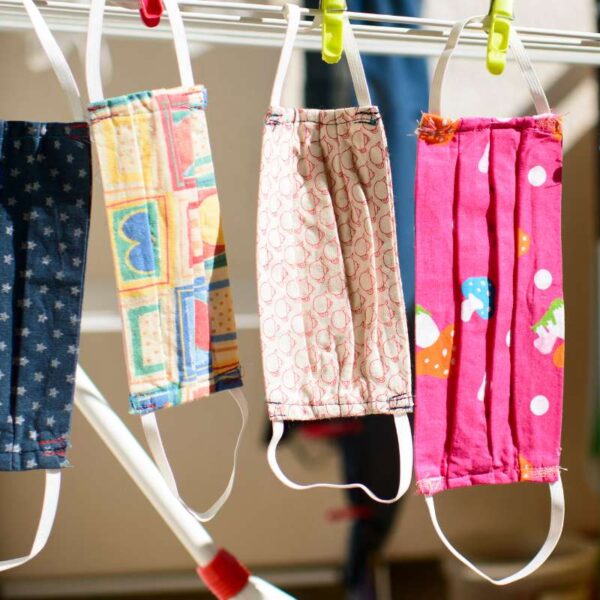 A collection of different custom printed face mask hanged together