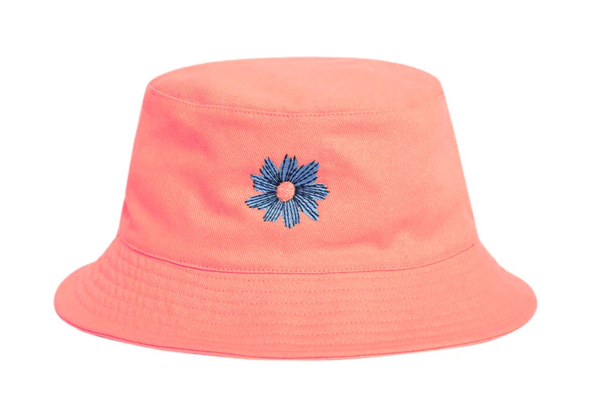 A custom embroidered bucket hat with a flower pattern in the center