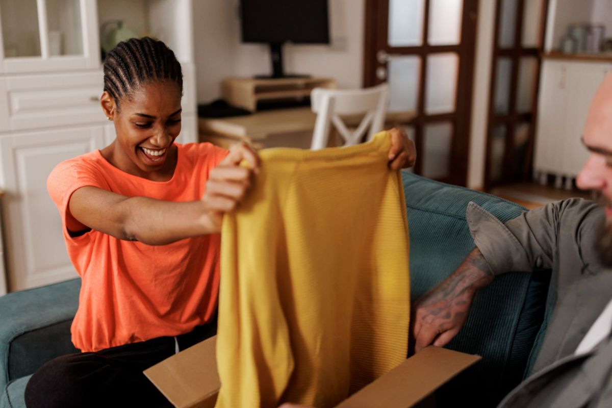 A lady is getting happy after receiving her crewneck sweatshirt for women