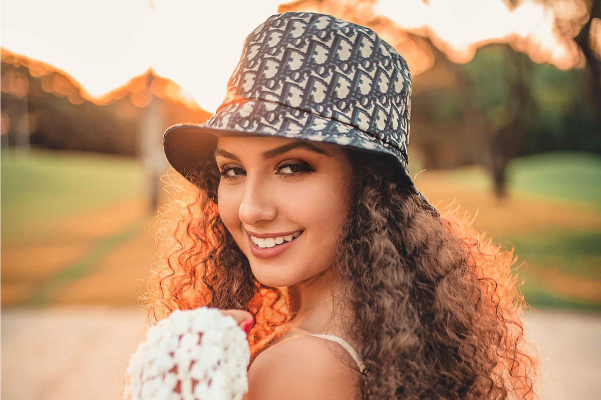A lady is smiling after wearing a custom bucket hat