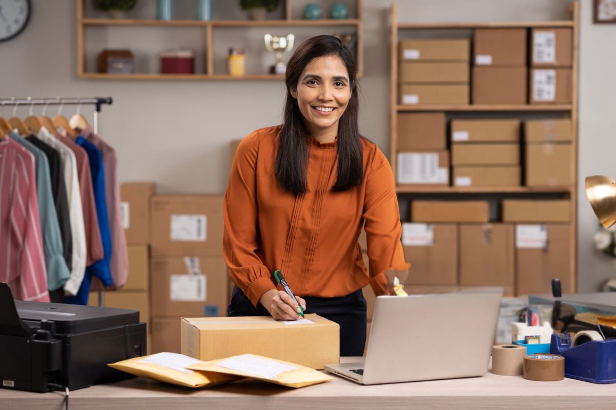 A lady selling sleeveless T-Shirts online