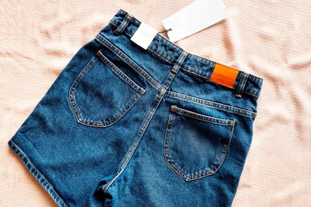 A pair of custom-printed denim shorts with a price tag on it