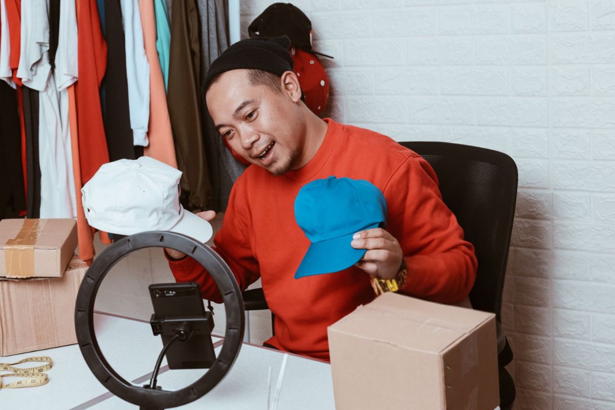 A person is marketing different types of hats online to attract buyers