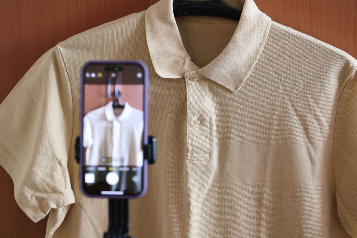 A person promoting his custom-designed polo T-shirt online