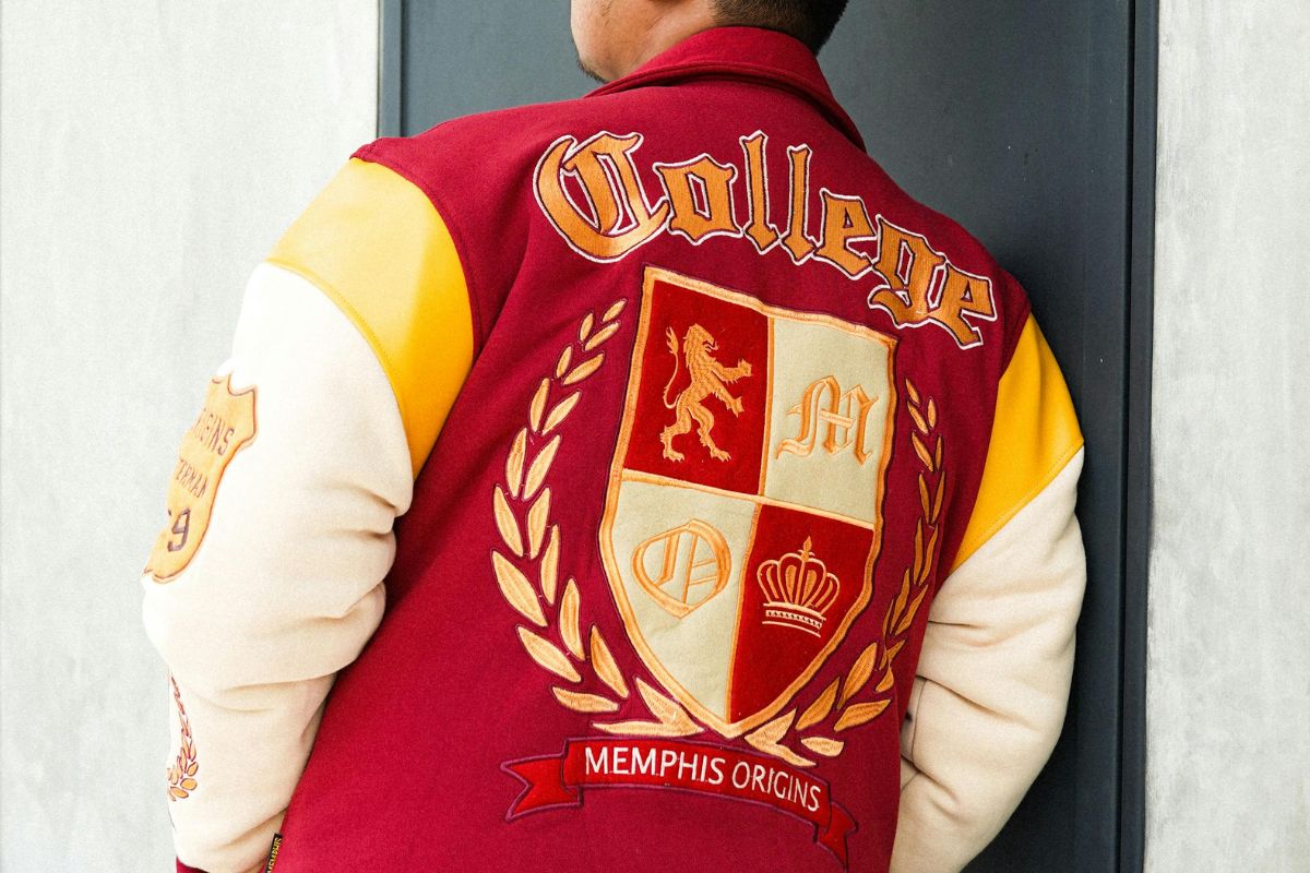 A person wearing a custom printed varsity jacket