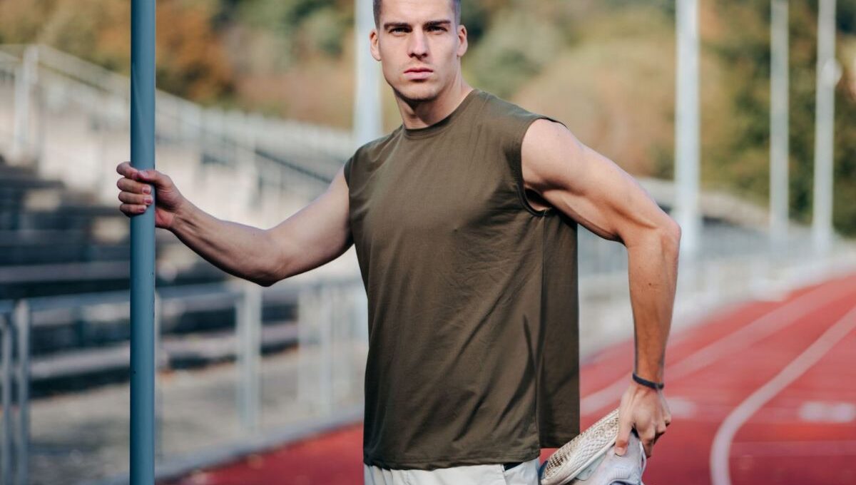 A person wearing a muscle tank t-shirt and exercising