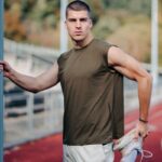 A person wearing a muscle tank t-shirt and exercising