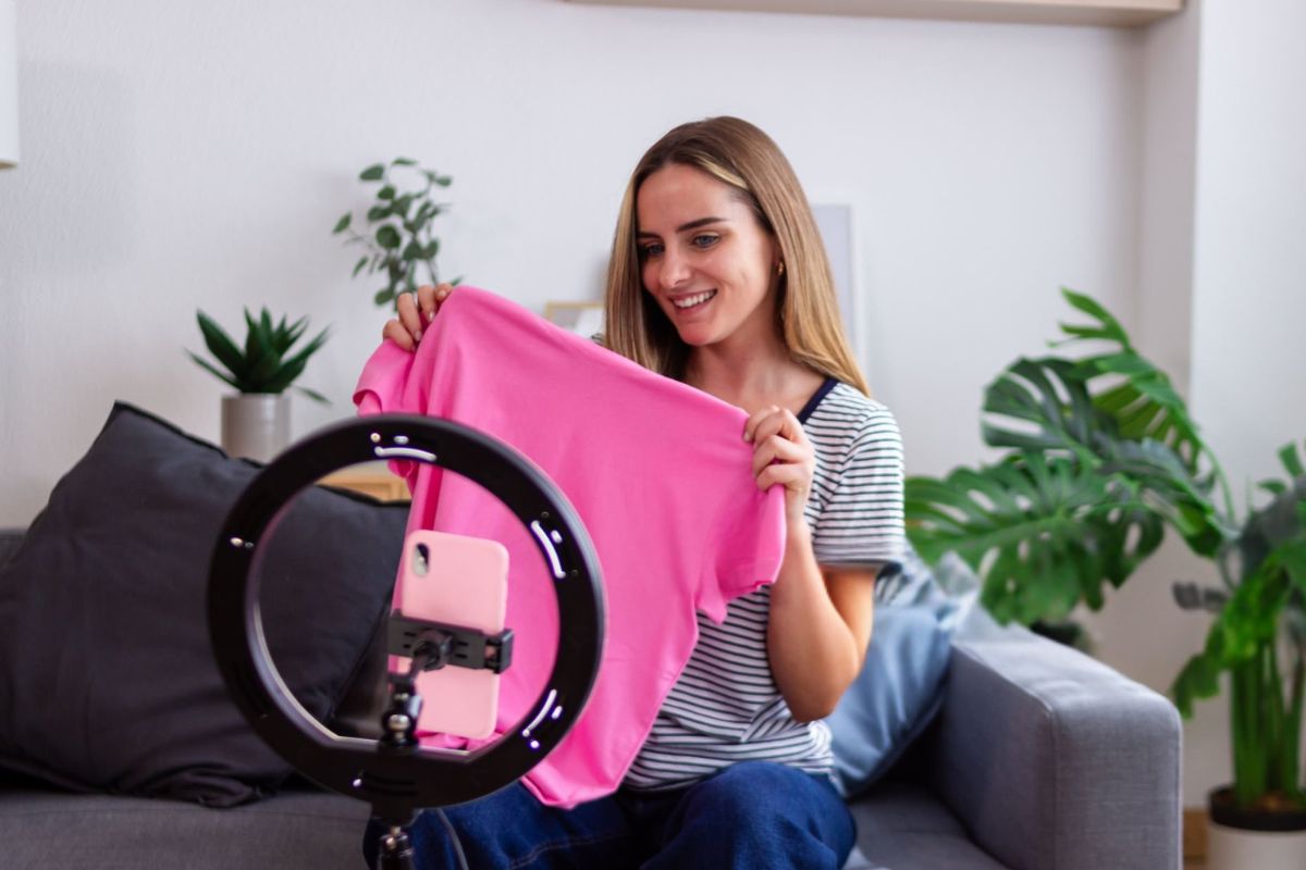 A woman marketing her T-shirt online to attract more customers