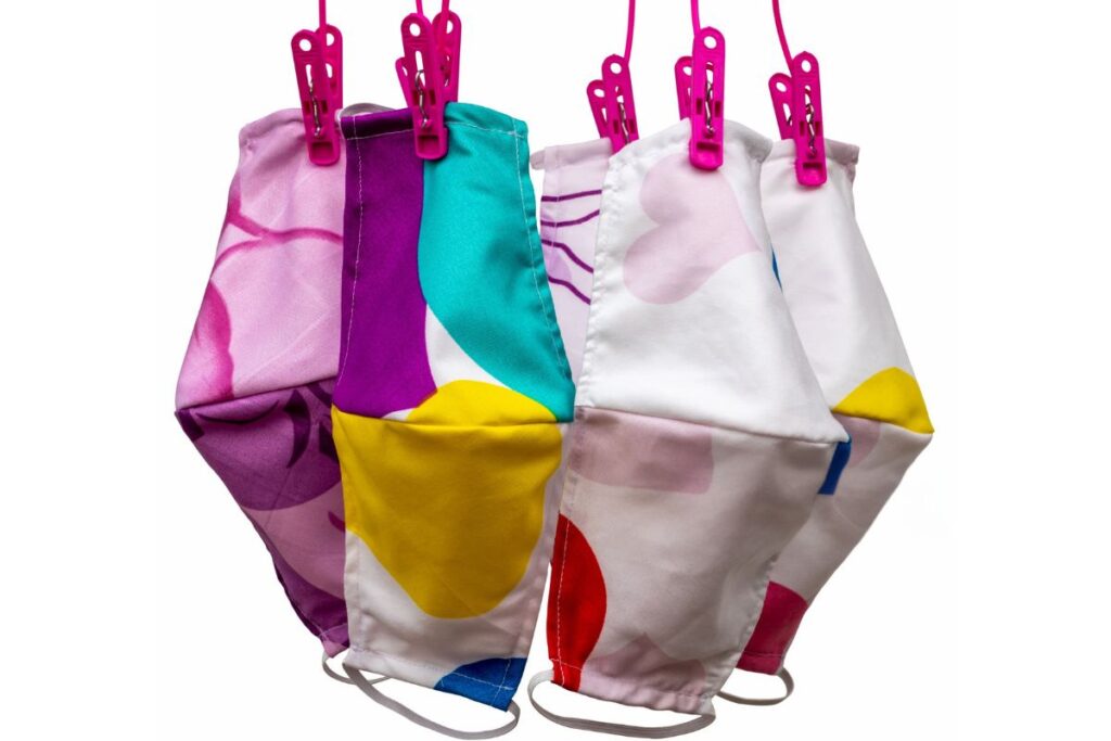 The image shows a collection of various printed face masks