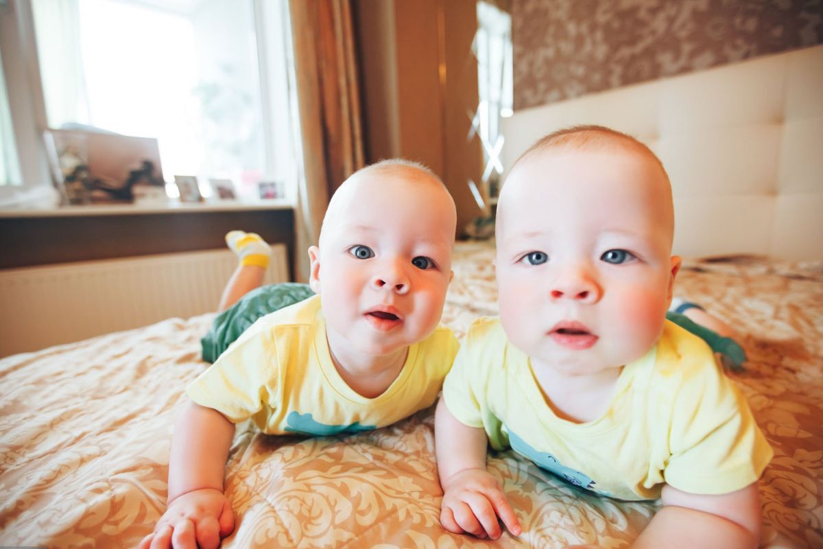 Two adorable babies wearing matching personalized baby T-shirts