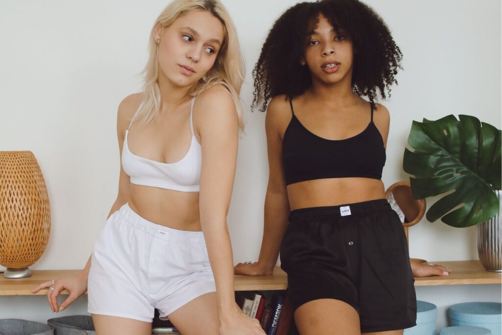 Two friends wearing women's high waisted shorts