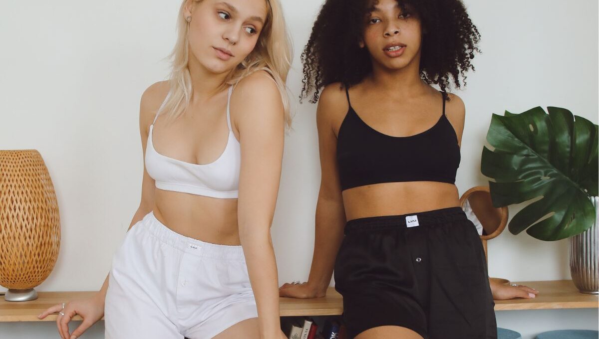 Two friends wearing women's high waisted shorts
