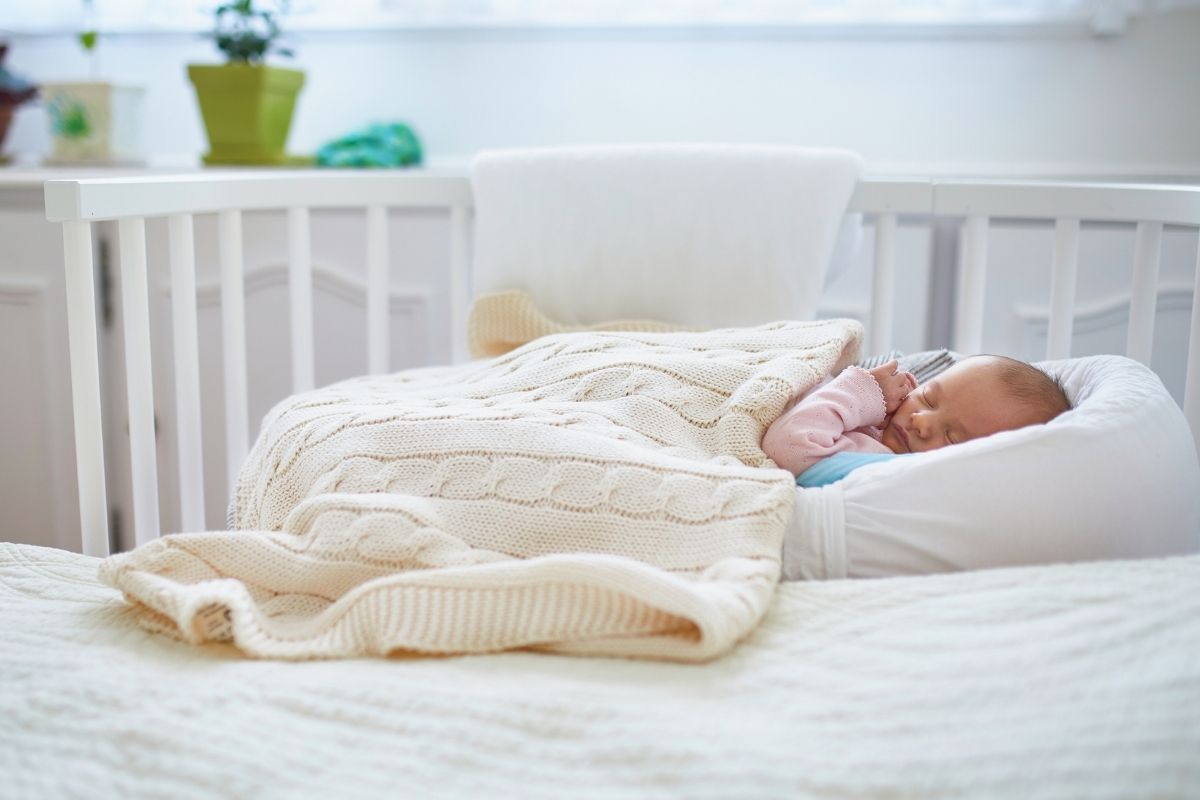 A baby peacefully sleeping with a custom blanket