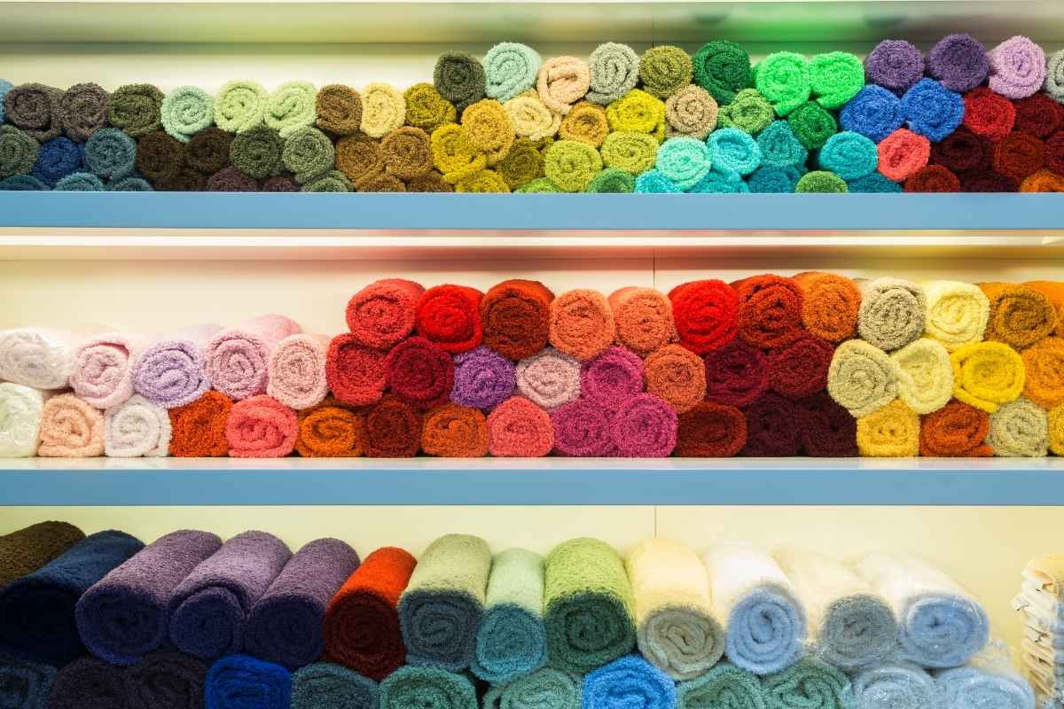 A collection of custom towels kept at a shop for sale