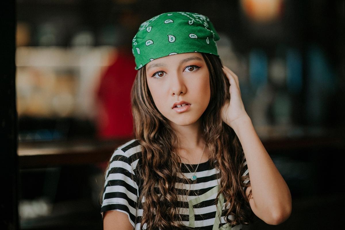 A girl with a custom-printed bandana on her head