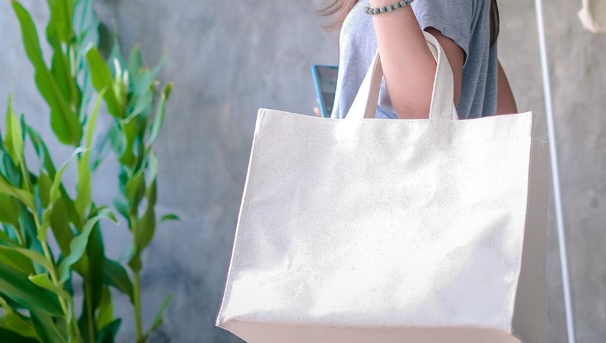 A lady holding personalized shopping bag