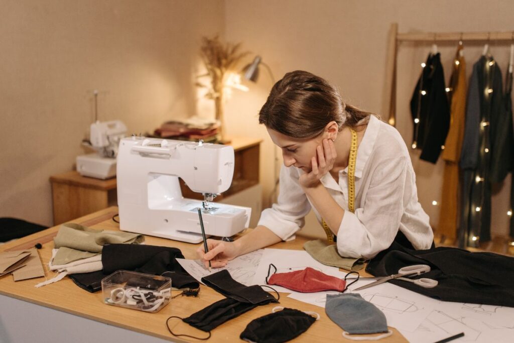 A lady is making different embroidered face covering