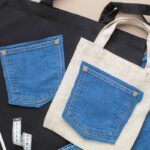 A person is customizing a tote bag